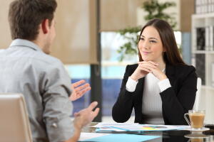 Businesswoman,Attending,Listening,To,A,Client,Who,Is,Talking,At