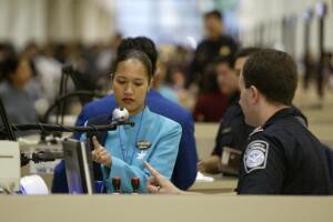 A US immigrations officer (R) instructs 
