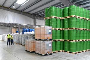 group of workers in the logistics industry work in a warehouse with chemicals
