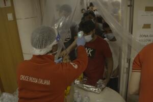 The Red Cross takes migrants temperatures.jpg