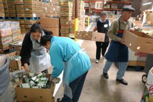 Charity Workers Sort Food For Distribution To Needy