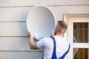 Technician Installing TV Satellite Dish