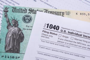 US Treasury check for stimulus in 2020 against a USA Form 1040