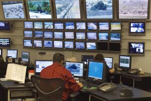A contractor monitors television cameras