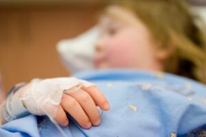 Little child, tied to the hospital bed