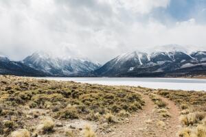 Dirt Road runs by glacial lake at foot of Mt. Elbert in Twin Lakes, Colorado.