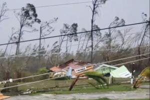 Uprooted trees, fallen power lines and the debris from damaged houses scattered on road as Hurricane Dorian sweeps through Marsh Harbour, Bahamas