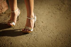 Woman Wearing White Heeled Sandals on Cement