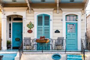 Old Dauphine street district in Louisiana famous town with blue painted house wall shutters colorful entrance building