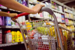 Woman,Buy,Products,With,Her,Trolley,At,Supermarket