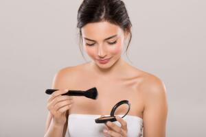 Woman applying make up