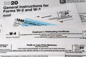 Various 2020 US IRS tax forms on a desktop.