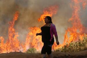 A resident looks at a wildfire in Vina del Mar