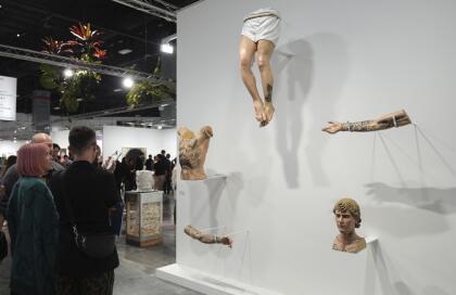 A wood carved sculpture portraying Justin Bieber's tattooed body parts titled "Incarnator," by artist Paul Pfeiffer, is displayed during Art Basel Miami Beach Wednesday, Dec. 4, 2024, in Miami Beach, Fla. (AP Photo/Lynne Sladky)