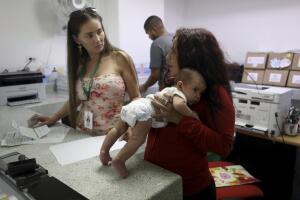 Arelys Pulido holds her two-month-old daughter in Colombia.