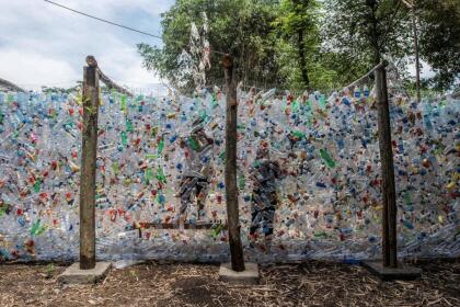 Indonesian activists from ECOTON (ecological observation and wetland conservation) prepare an installation made with used plastic, including 4,444 bottles, collected from the river in Gresik on September 17, 2021, to raise public awareness of plastic waste in rivers and oceans. (Photo by JUNI KRISWANTO / AFP) (Photo by JUNI KRISWANTO/AFP via Getty Images)