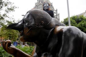 A group of environmentalists place gas masks on the faces of the sculptures of the artist Fernando Botero, protesting the high levels of air pollution in Medellin