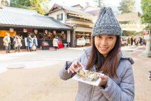 mujer_comiendo_ostras_en_miyajima_japon.jpg