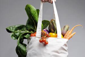 Cotton shopping bag overflowing with vegetables