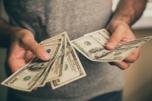 A man holds dollars in his hands