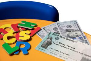 Illustration of the 2021 child tax credit check with cash due from the IRS in the summer