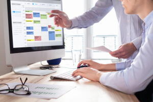 Colleagues,Planning,A,Meeting,With,Calendar,Software,On,Computer,,Search