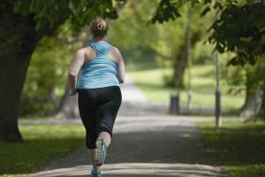 Young woman running on path, rear view