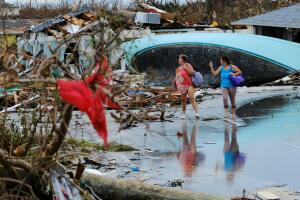 Women walk through the rubble in the aftermath of Hurricane Dorian on the Great Abaco island town of Marsh Harbour