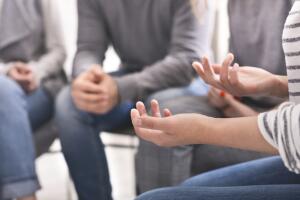 Emotional woman sharing her story during support session