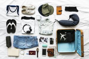 Aerial view of clothes preparing to pack on bed