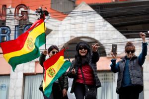 People celebrate after Bolivia's President Evo Morales announced his resignation in La Paz