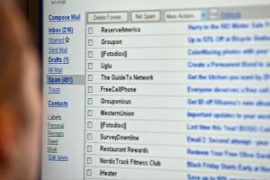 A woman looks at her email on a computer