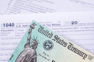 US Treasury check for stimulus in 2020 against a USA Form 1040