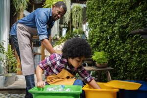 African Descent Kid Separating Recyclable Trash