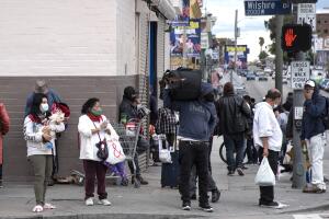 A crowd of people wearing face masks in Los Angeles during COVID-19 quarantine