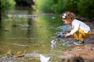 Little girl with a paper boat