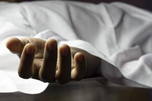 person laying dead with outstretched hand