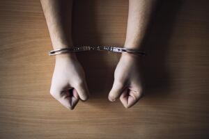 Top view of prisoner's hands in handcuffs. Verdict at the court.