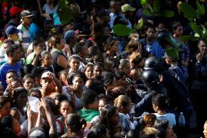 Relatives of inmates at the General Command of the Carabobo Police wait outside the prison in Valencia