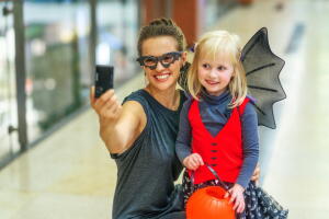mother and child with digital camera taking selfie