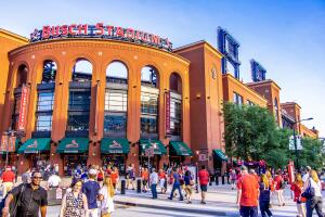 Sports fans outside of Busch Stadium in the evening